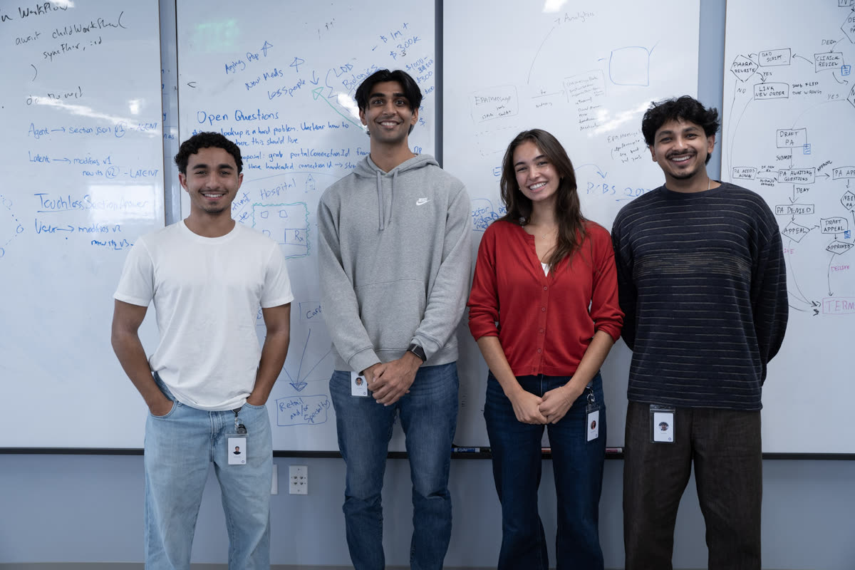 Four Latent teammates at a whiteboard