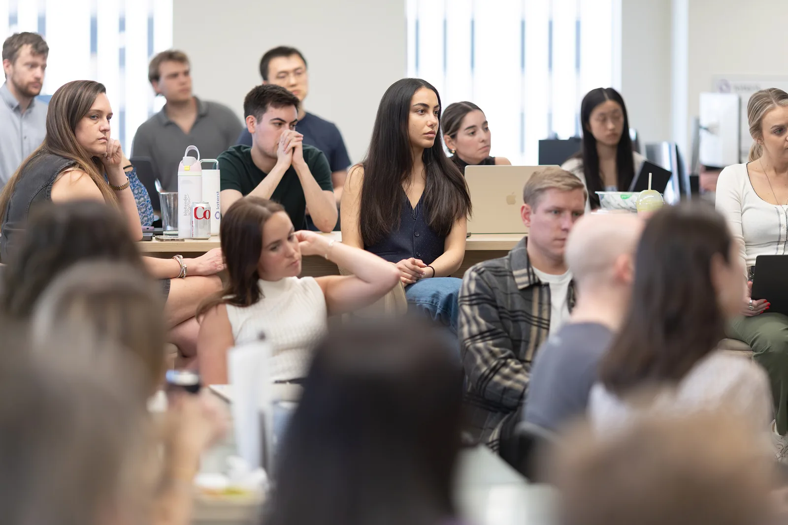 The team listening in a full room during an all-hands session