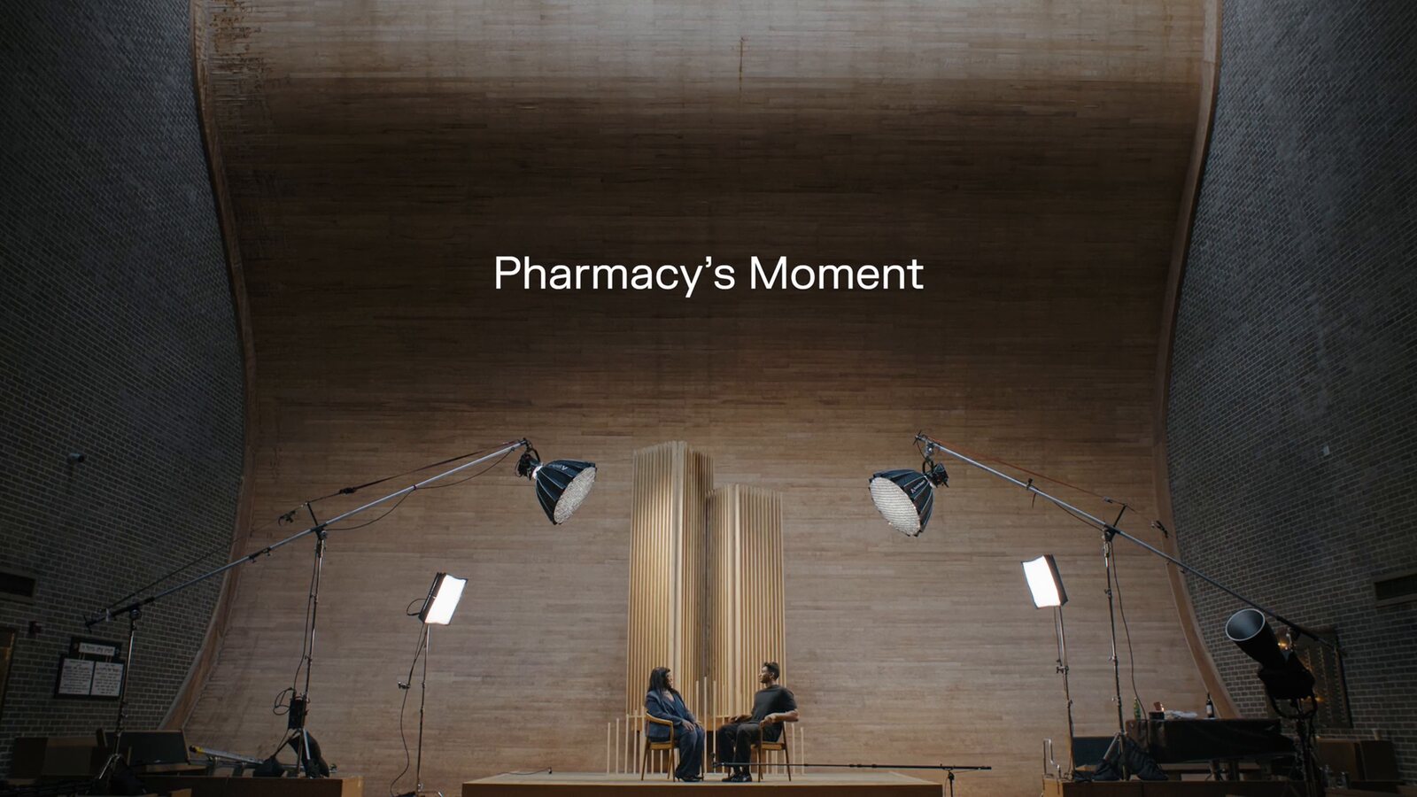 The film's title card: Pharmacy's Moment, over the two chairs on the set